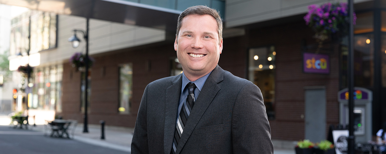 Photo of David Rosenau in front of an STCU building