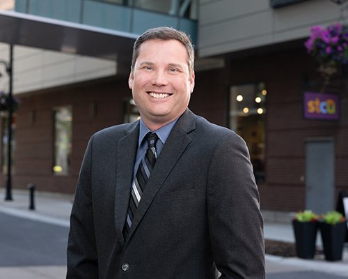 Photo of David Rosenau in front of an STCU building