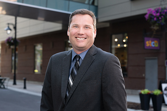 Photo of David Rosenau in front of an STCU building