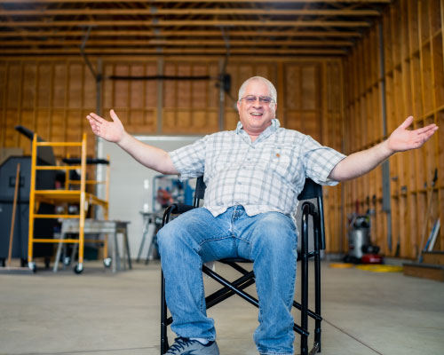 John Nordine sitting in his garage