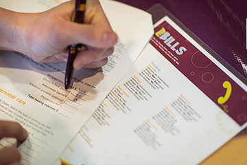 Close up photo of someone filling out paperwork