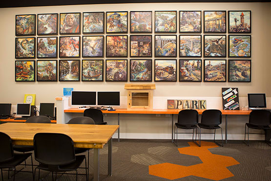 Photo of a photo collage on the wall of Spark Central