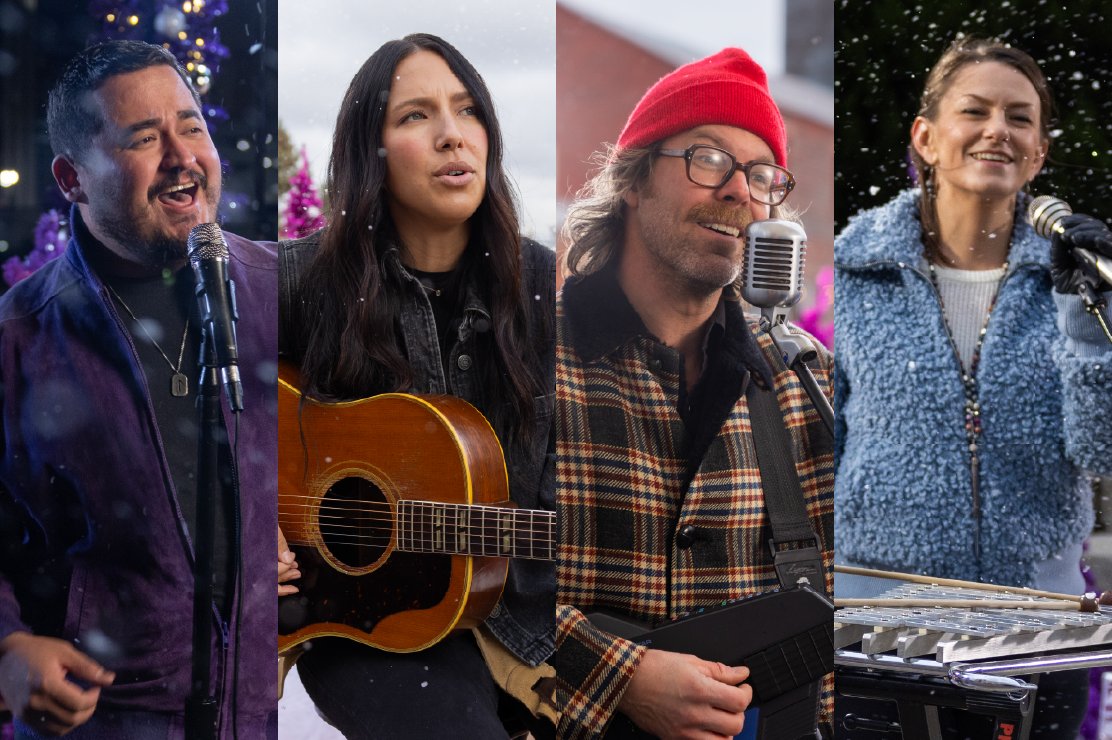 Photo of four musicians singing. 
