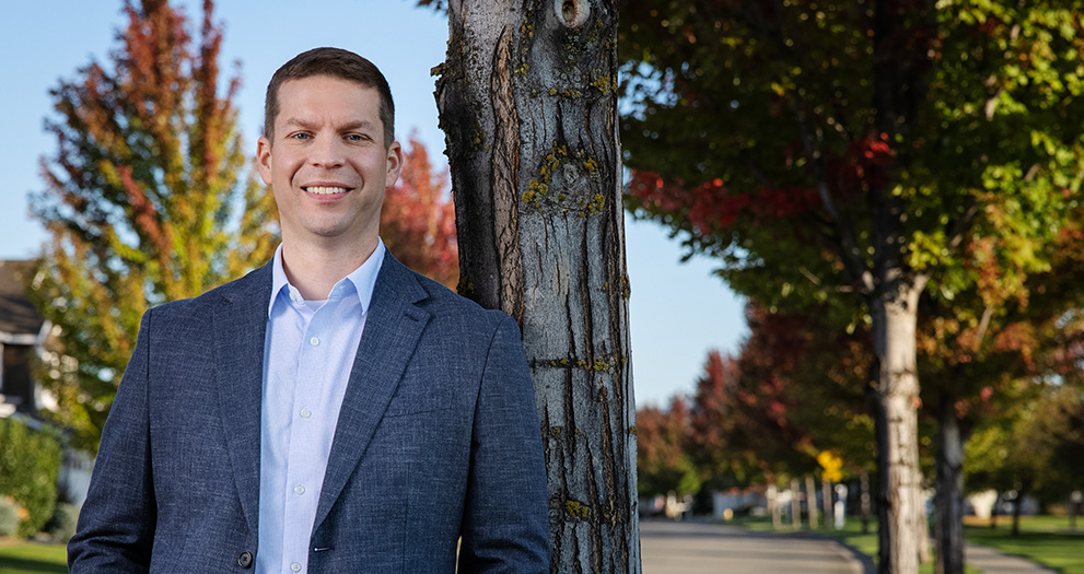 Photo of Nick Dotson standing next to a tree