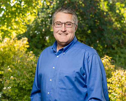 A photo of Terry Wiyrick outside, with a tree in the background