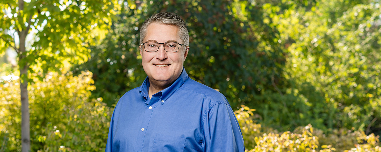 A photo of Terry Wiyrick outside, with a tree in the background