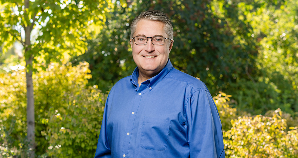 A photo of Terry Wiyrick outside, with a tree in the background