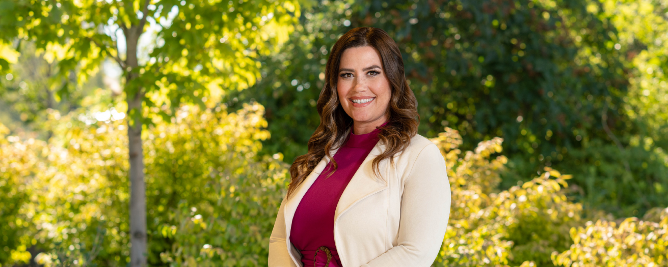 Financial Advisor Anna Bowers standing in front of trees