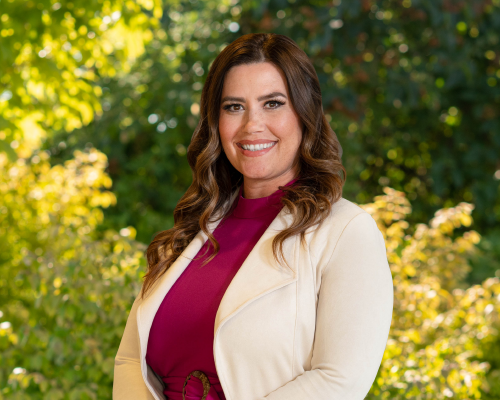 Financial Advisor Anna Bowers standing in front of trees