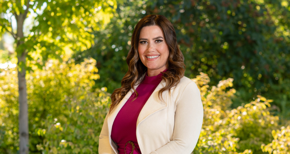 Financial Advisor Anna Bowers standing in front of trees