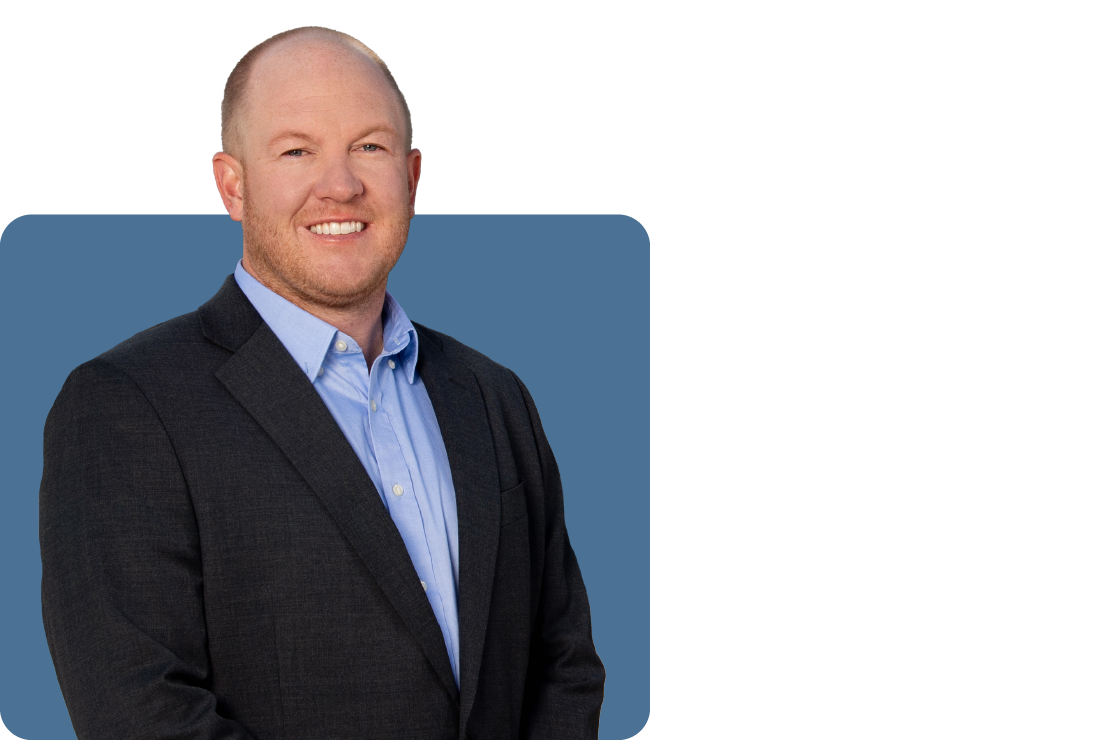 Headshot photo of Brenton Harting set against a blue backdrop