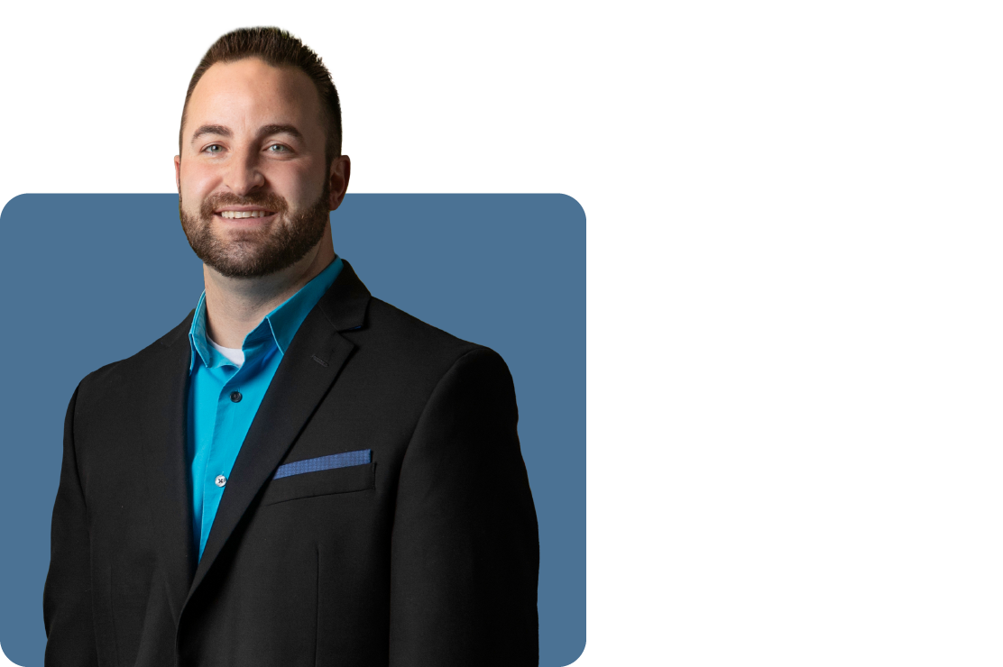 Headshot photo of Travis Clemons set against a blue backdrop